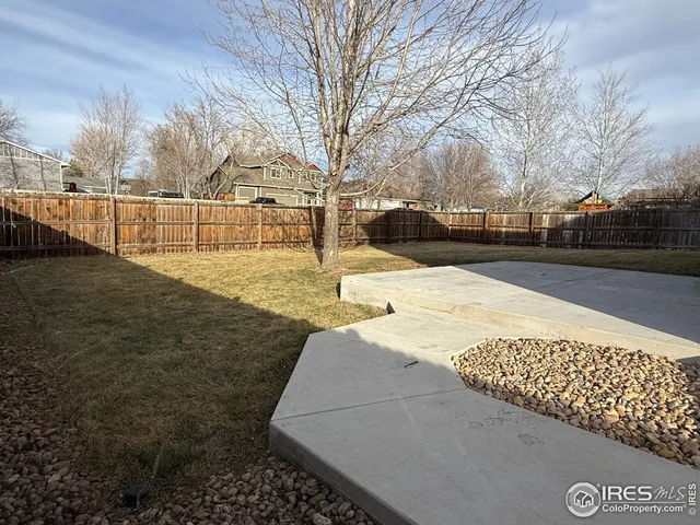 a view of a yard with snow on the road