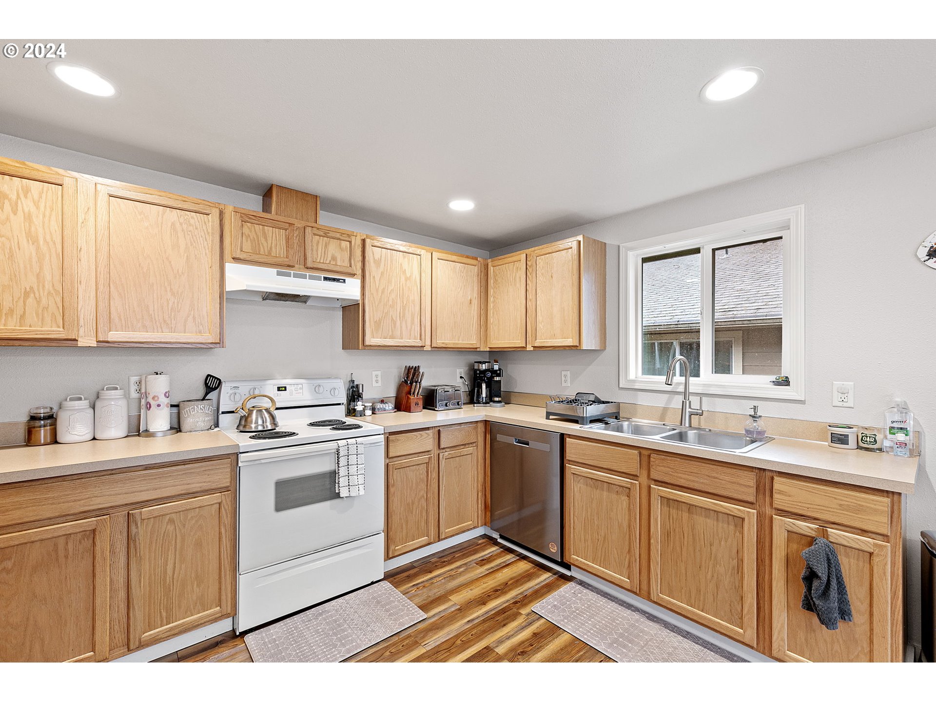 183 35th Street Springfield, OR 97478 - Photo 14 of 36 a kitchen with a sink stove cabinets and wooden floor