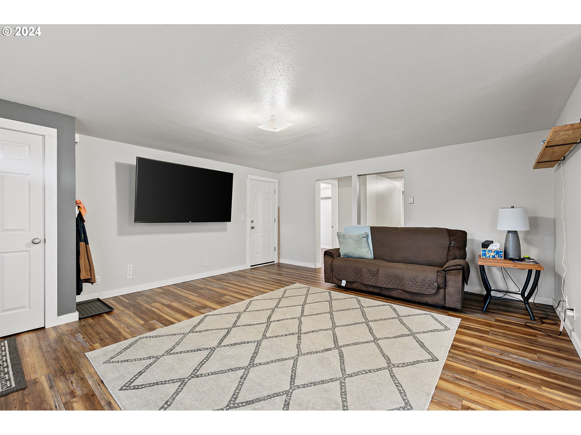 183 35th Street Springfield, OR 97478 - Photo 8 of 36 a living room with a flat screen tv and a rug