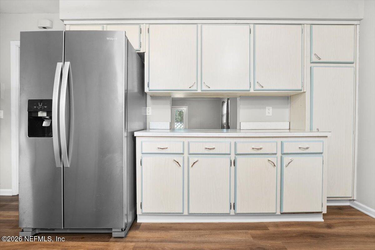 5376 Sanders Road Jacksonville, FL 32277 - Photo 16 of 44 a view of a refrigerator in kitchen with white cabinets