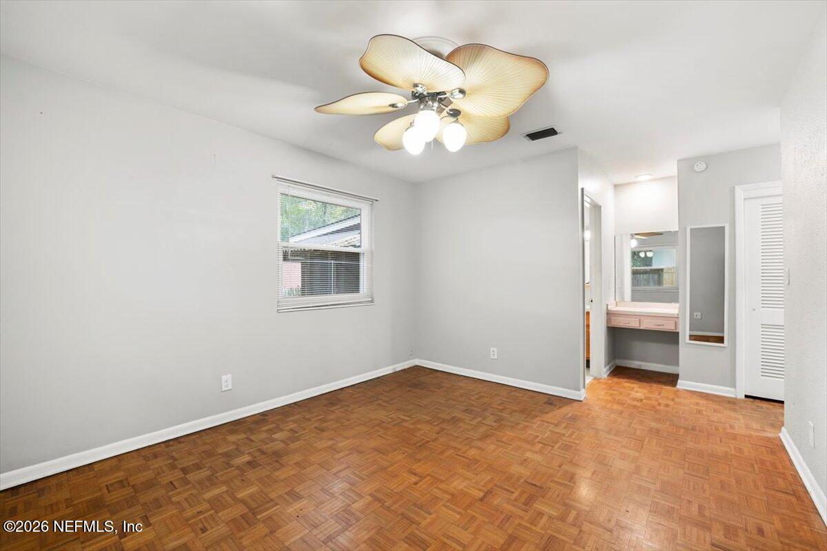 5376 Sanders Road Jacksonville, FL 32277 - Photo 19 of 44 a view of an empty room with a chandelier fan