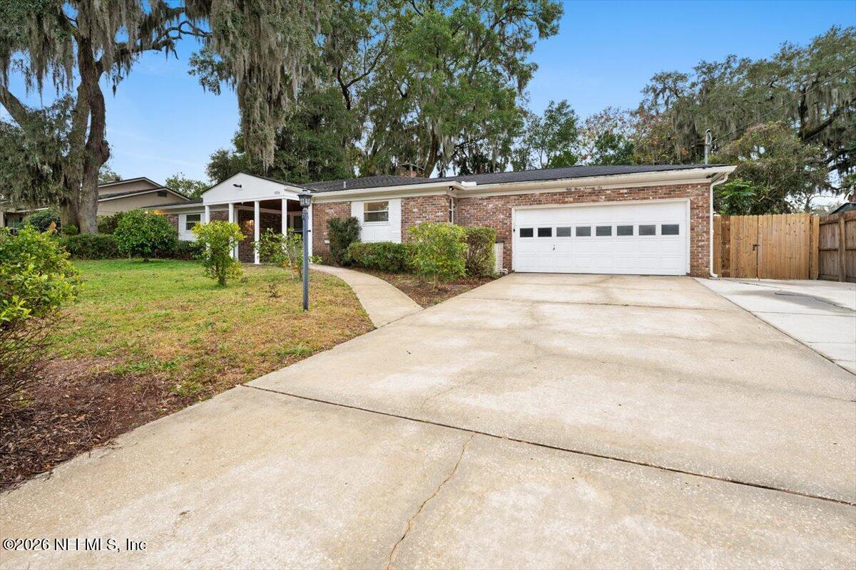 5376 Sanders Road Jacksonville, FL 32277 - Photo 2 of 44 a view of house with outdoor space and garden