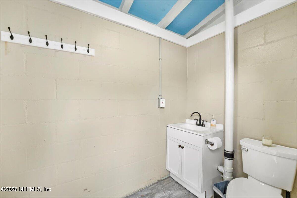 5376 Sanders Road Jacksonville, FL 32277 - Photo 32 of 44 a bathroom with a sink a toilet and a mirror