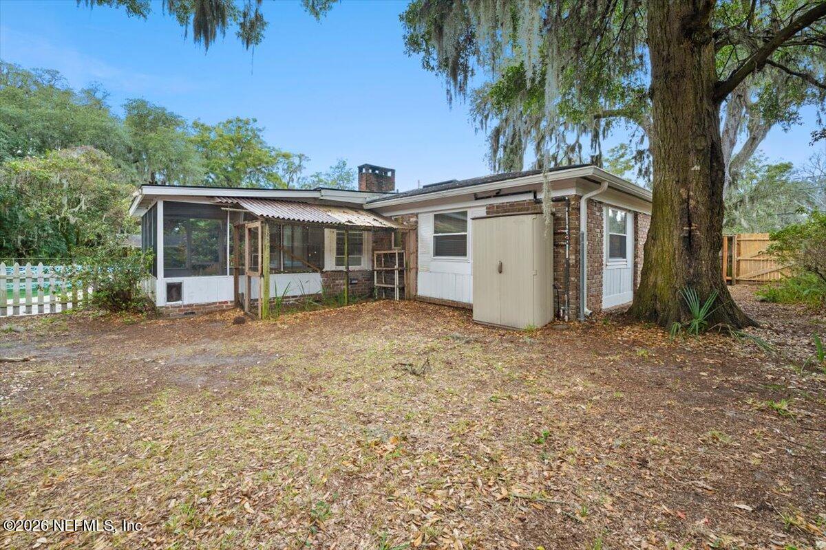 5376 Sanders Road Jacksonville, FL 32277 - Photo 40 of 44 front view of a house with a yard and potted plants