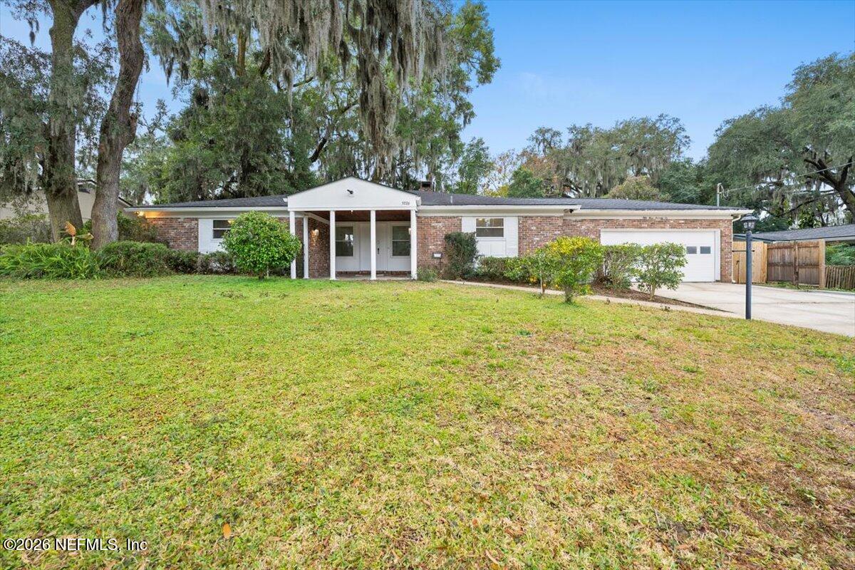 5376 Sanders Road Jacksonville, FL 32277 - Photo 43 of 44 a front view of a house with a yard