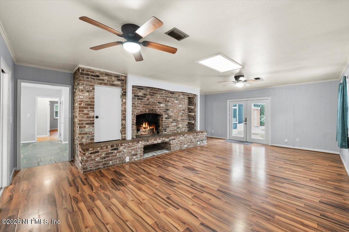5376 Sanders Road Jacksonville, FL 32277 - Photo 6 of 44 a living room with furniture and a fireplace