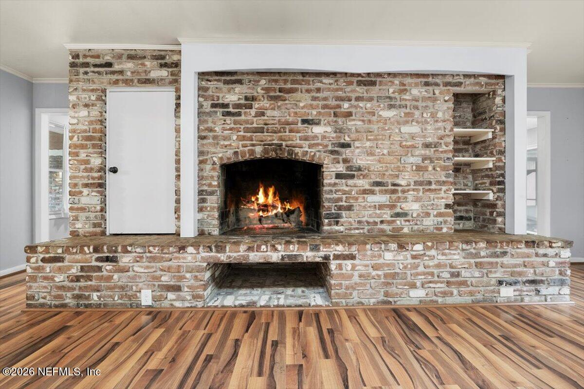5376 Sanders Road Jacksonville, FL 32277 - Photo 7 of 44 a view of fireplace with wooden floor