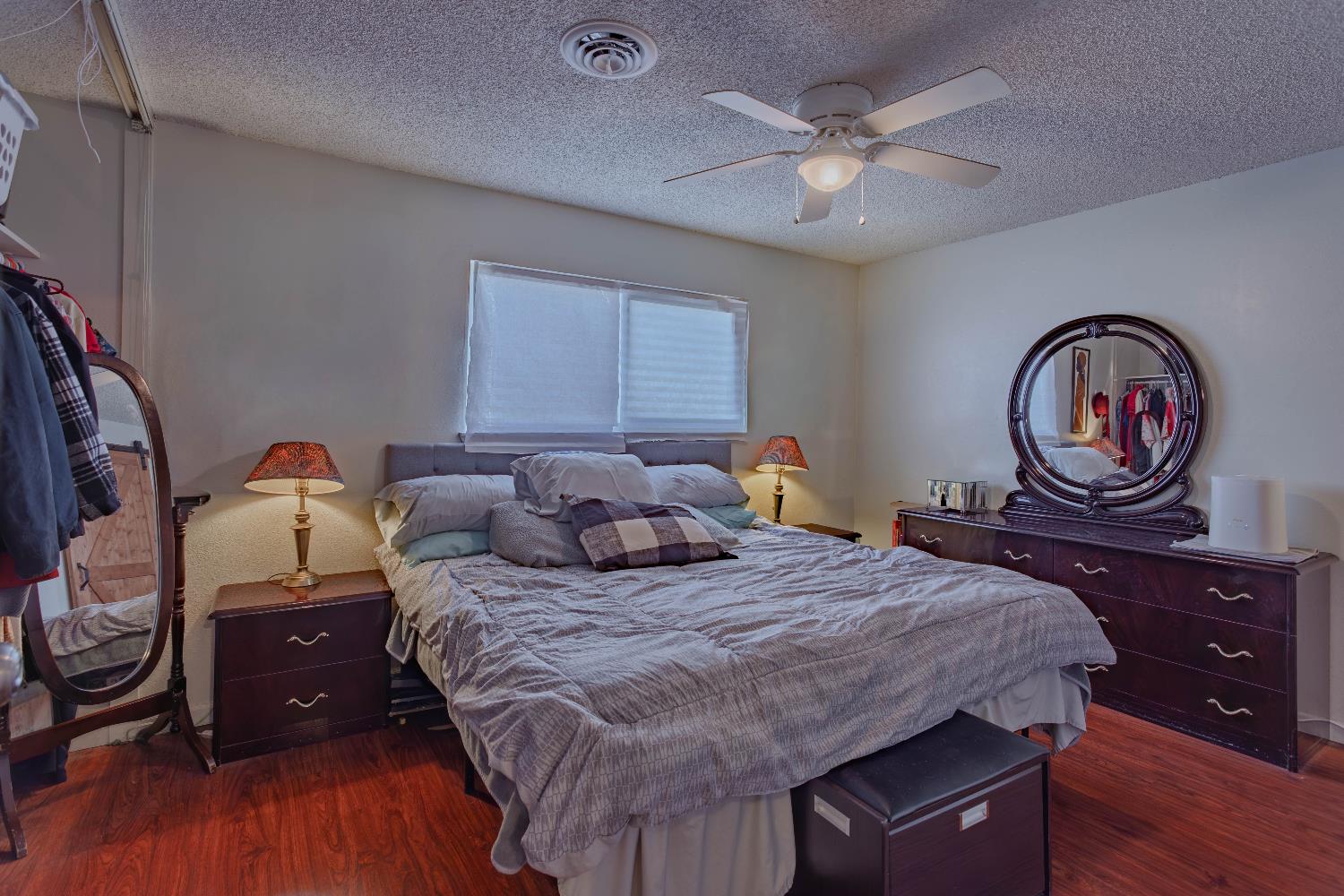 2322 Foust Street Marysville, CA 95901 - Photo 18 of 26 a bedroom with a bed a dresser and wooden floor