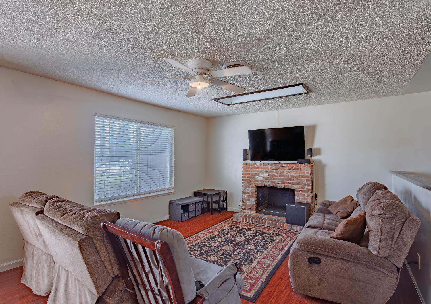 2322 Foust Street Marysville, CA 95901 - Photo 5 of 26 a living room with furniture a flat screen tv and a fireplace