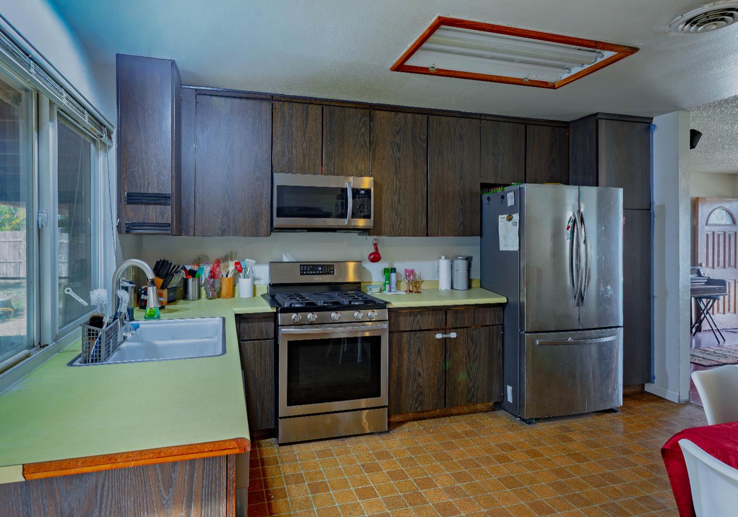 2322 Foust Street Marysville, CA 95901 - Photo 10 of 26 a kitchen with kitchen island a stove and a refrigerator