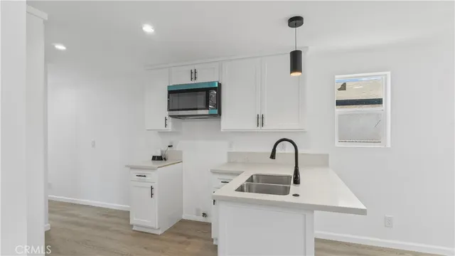 a kitchen with a sink and a microwave