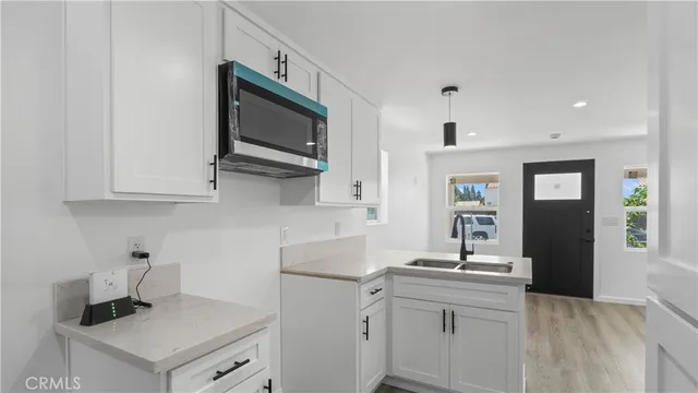 a kitchen with stainless steel appliances granite countertop a sink a stove and a refrigerator