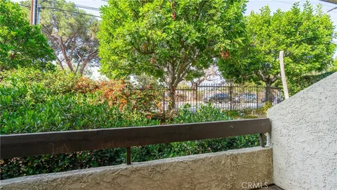 a view of a garden with a tree in the background