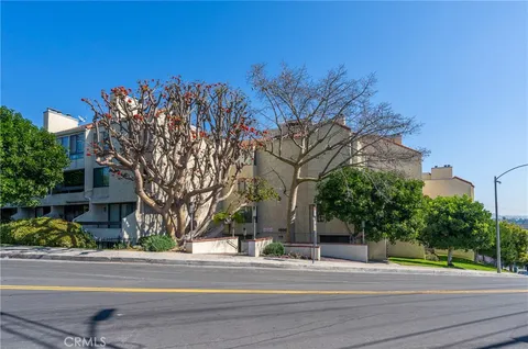 a view of a multi story building in a yard