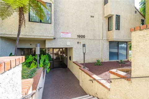 a view of an house with backyard space and a car park