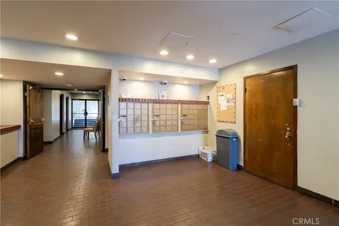 a view of empty room with wooden floor and furniture