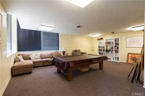 a living room with furniture a table and bookshelf