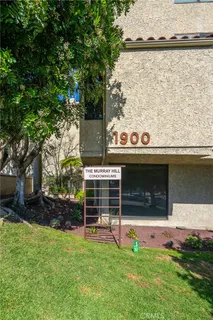 an aerial view of multi story residential apartment building with yard and parking space