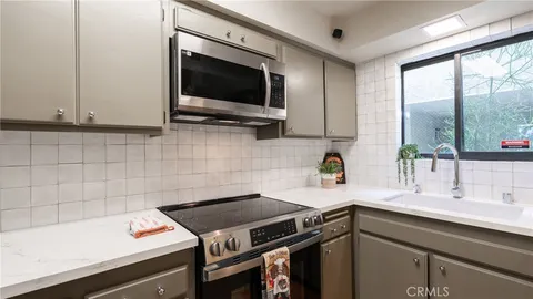 a kitchen with a sink and a microwave