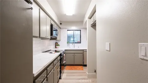 a kitchen with a sink stove and cabinets