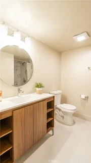 a bathroom with a toilet a sink and a mirror