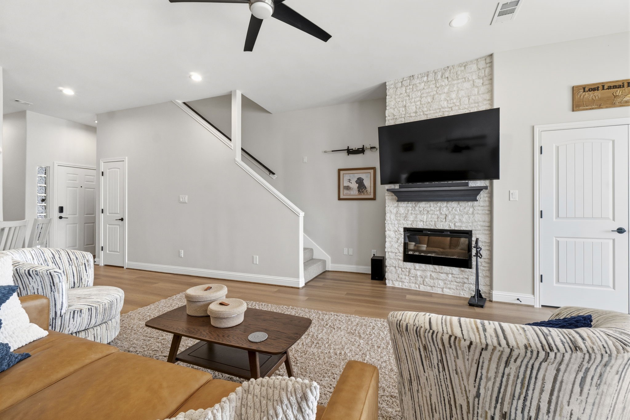2 Key Harbour Conroe, TX 77356 - Photo 16 of 41 a living room with furniture a flat screen tv and a fireplace