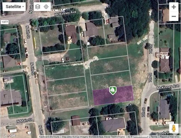 a black white refrigerator freezer sitting next to a white cabinet