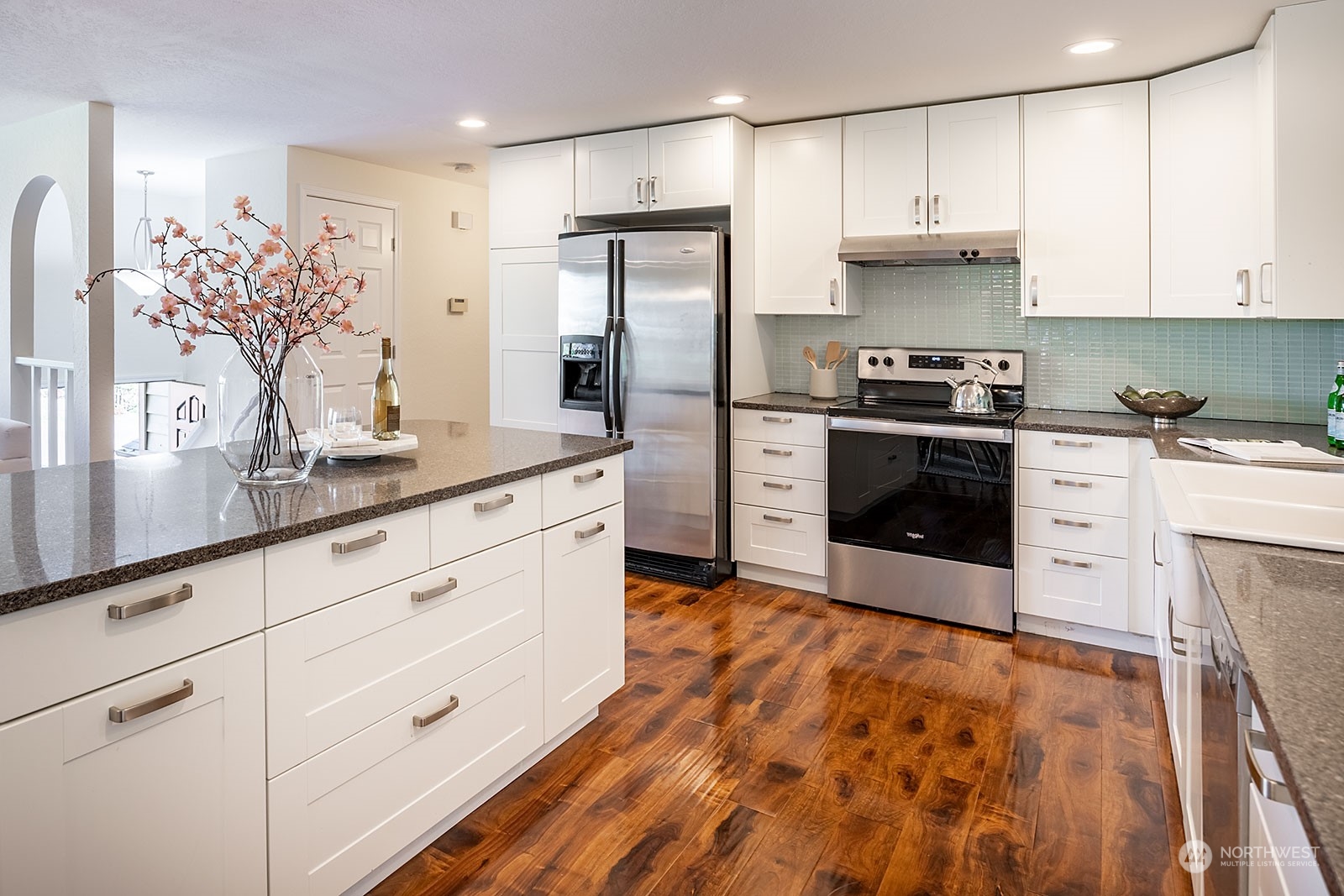 2116 242nd Street Southwest Bothell, WA 98021 - Photo 12 of 38 a kitchen with stainless steel appliances granite countertop a sink a stove a refrigerator and cabinets