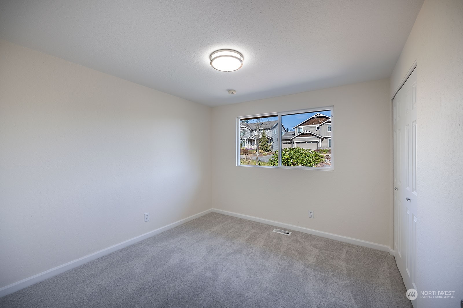 2116 242nd Street Southwest Bothell, WA 98021 - Photo 17 of 38 an empty room with a painting on the wall
