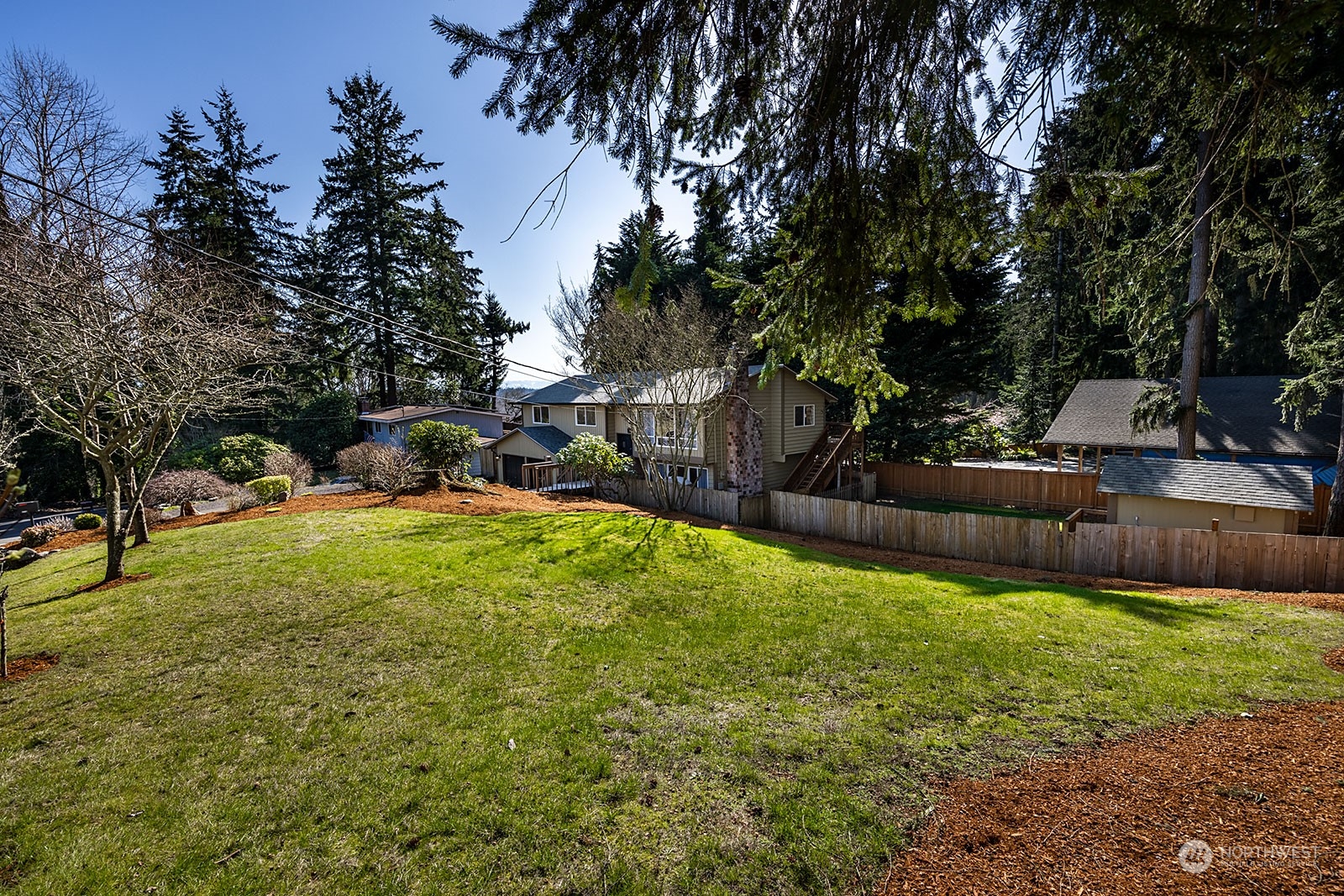 2116 242nd Street Southwest Bothell, WA 98021 - Photo 5 of 38 a backyard of a house with table and chairs