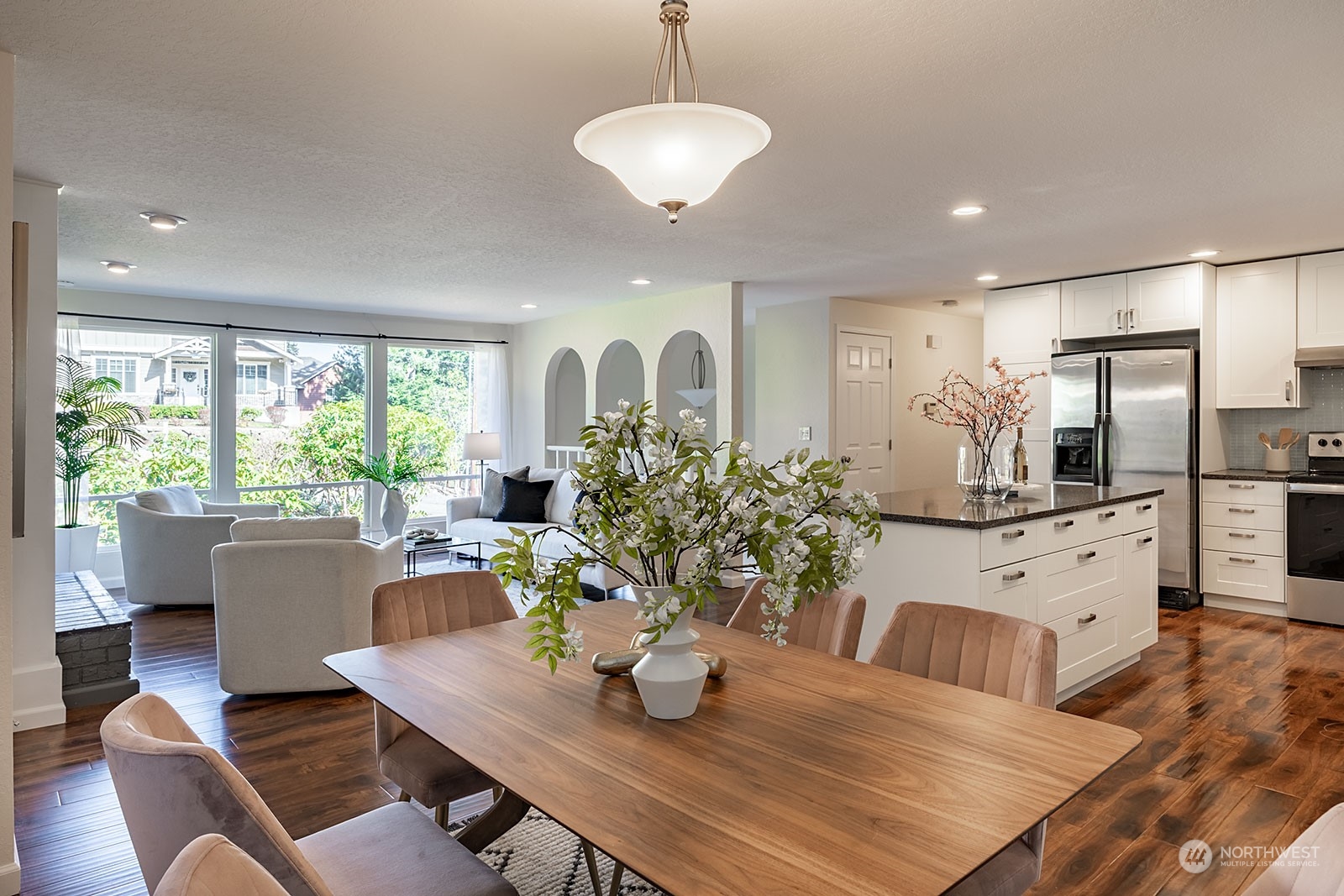 2116 242nd Street Southwest Bothell, WA 98021 - Photo 8 of 38 a living room with kitchen island furniture and a chandelier