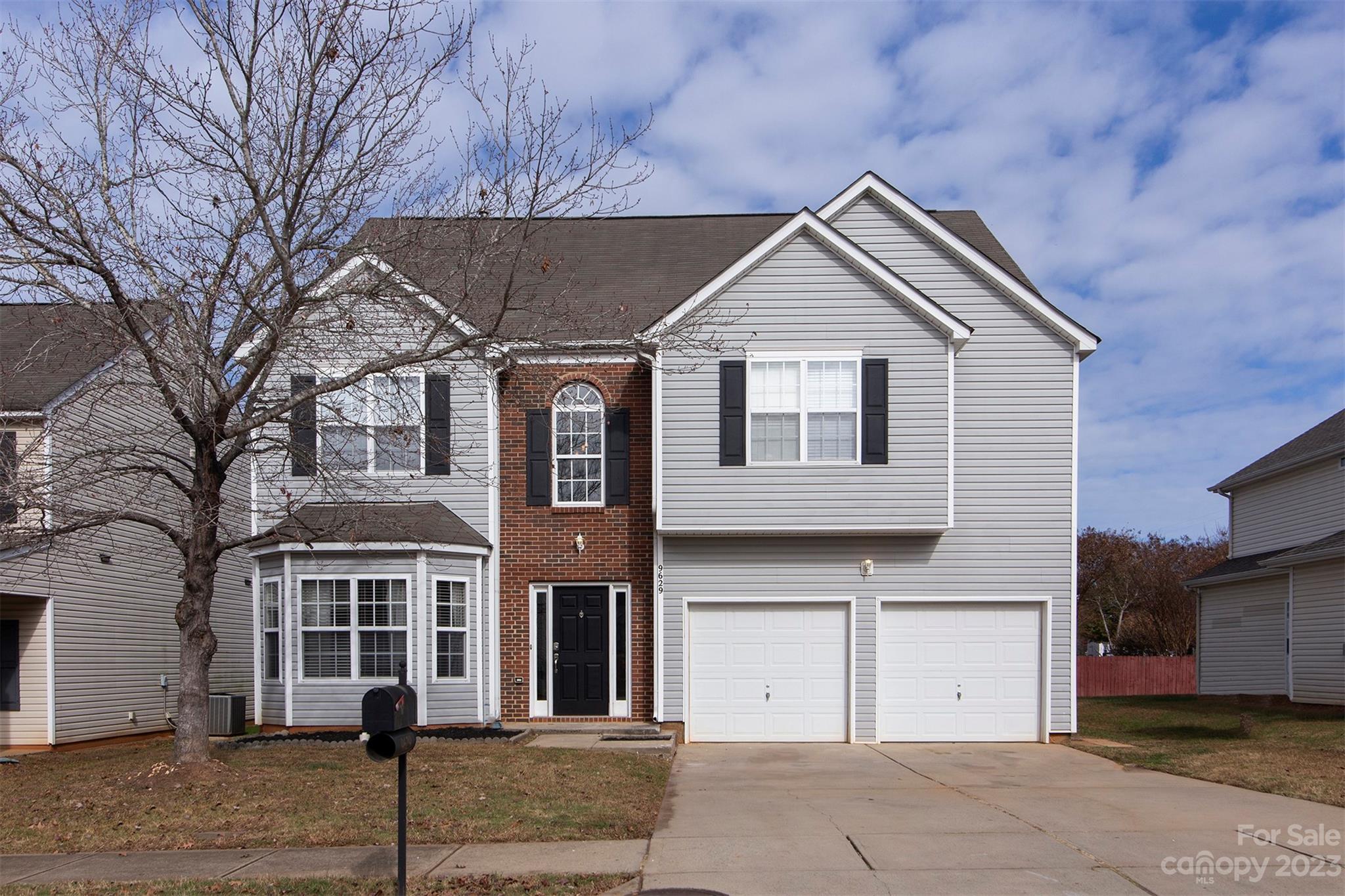 9629 Rothman Lane Charlotte, NC 28215 - Photo 1 of 24 a view of a white house with large windows