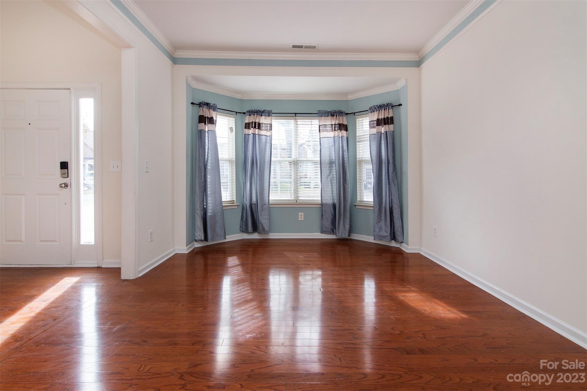 9629 Rothman Lane Charlotte, NC 28215 - Photo 11 of 24 a view of lot of wooden floor and windows in a room
