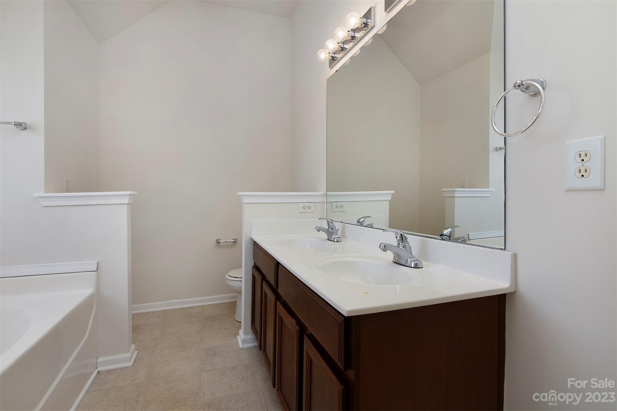 9629 Rothman Lane Charlotte, NC 28215 - Photo 14 of 24 a bathroom with a sink and a mirror