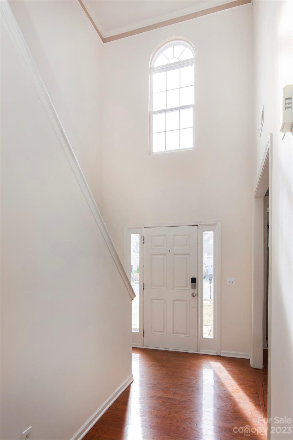 9629 Rothman Lane Charlotte, NC 28215 - Photo 3 of 24 an empty room with wooden floor and windows