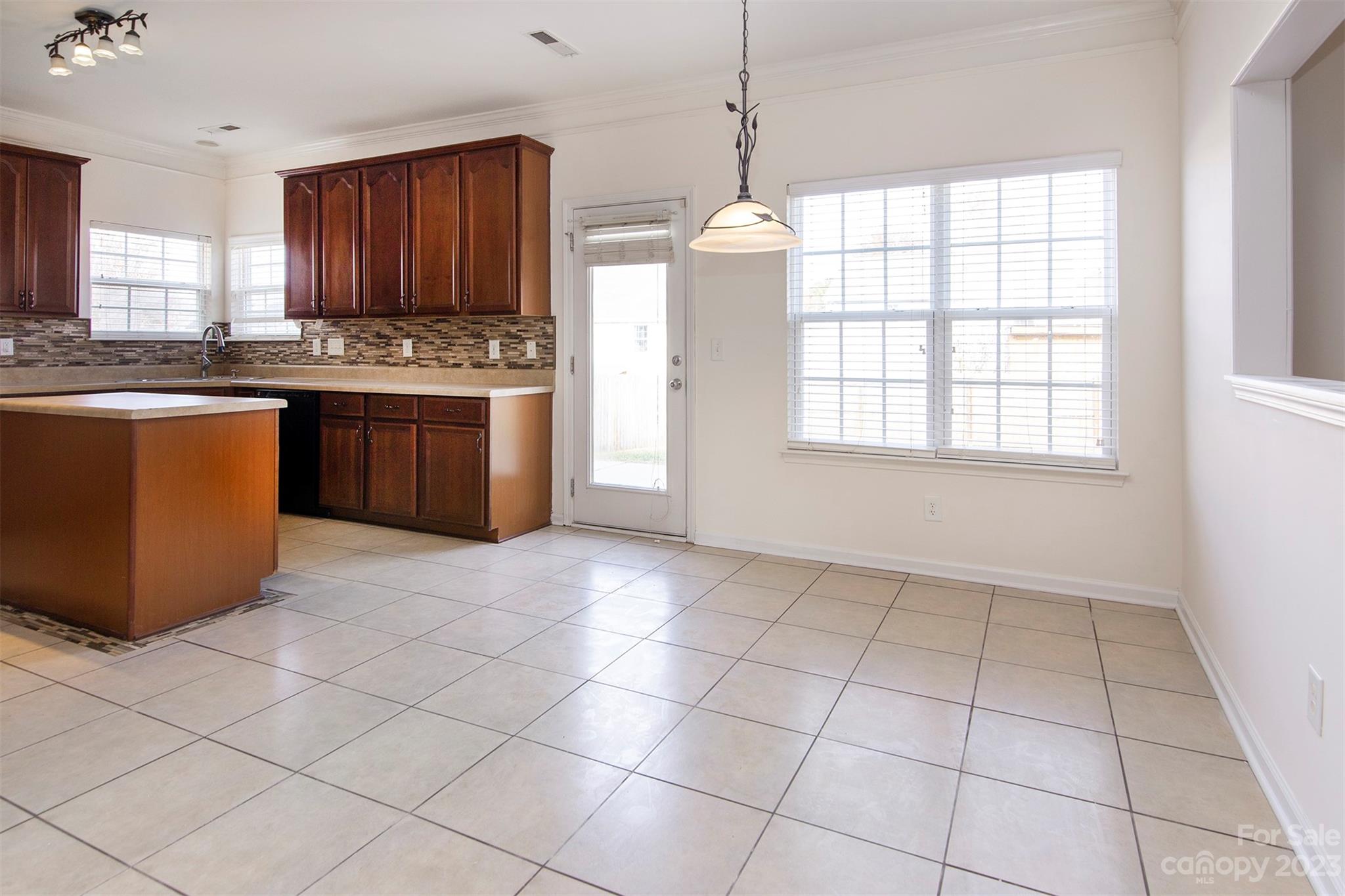 9629 Rothman Lane Charlotte, NC 28215 - Photo 6 of 24 a kitchen with stainless steel appliances granite countertop a stove a sink a refrigerator a counter top space and cabinets