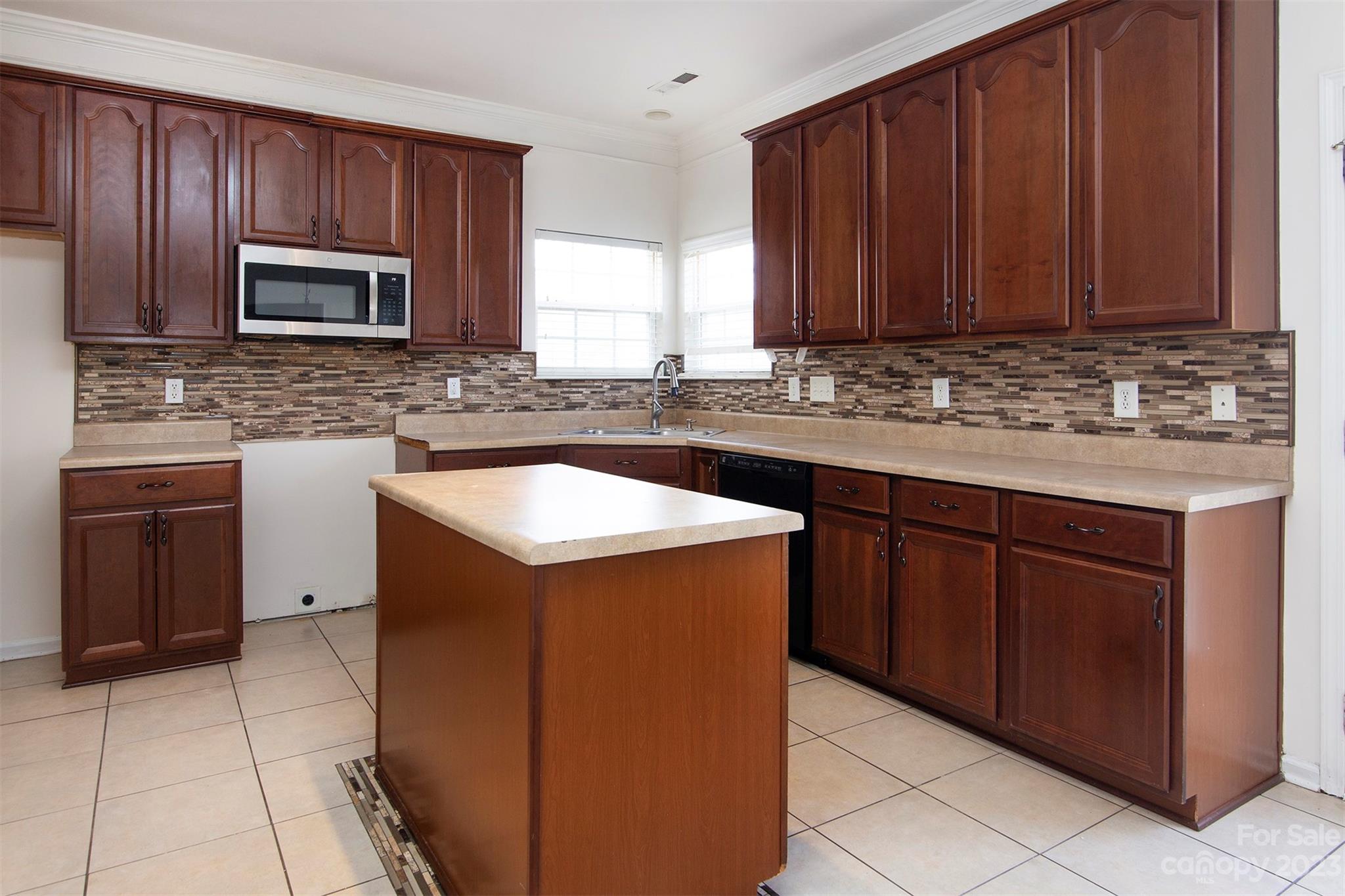9629 Rothman Lane Charlotte, NC 28215 - Photo 7 of 24 a kitchen with stainless steel appliances granite countertop wooden cabinets a sink and dishwasher