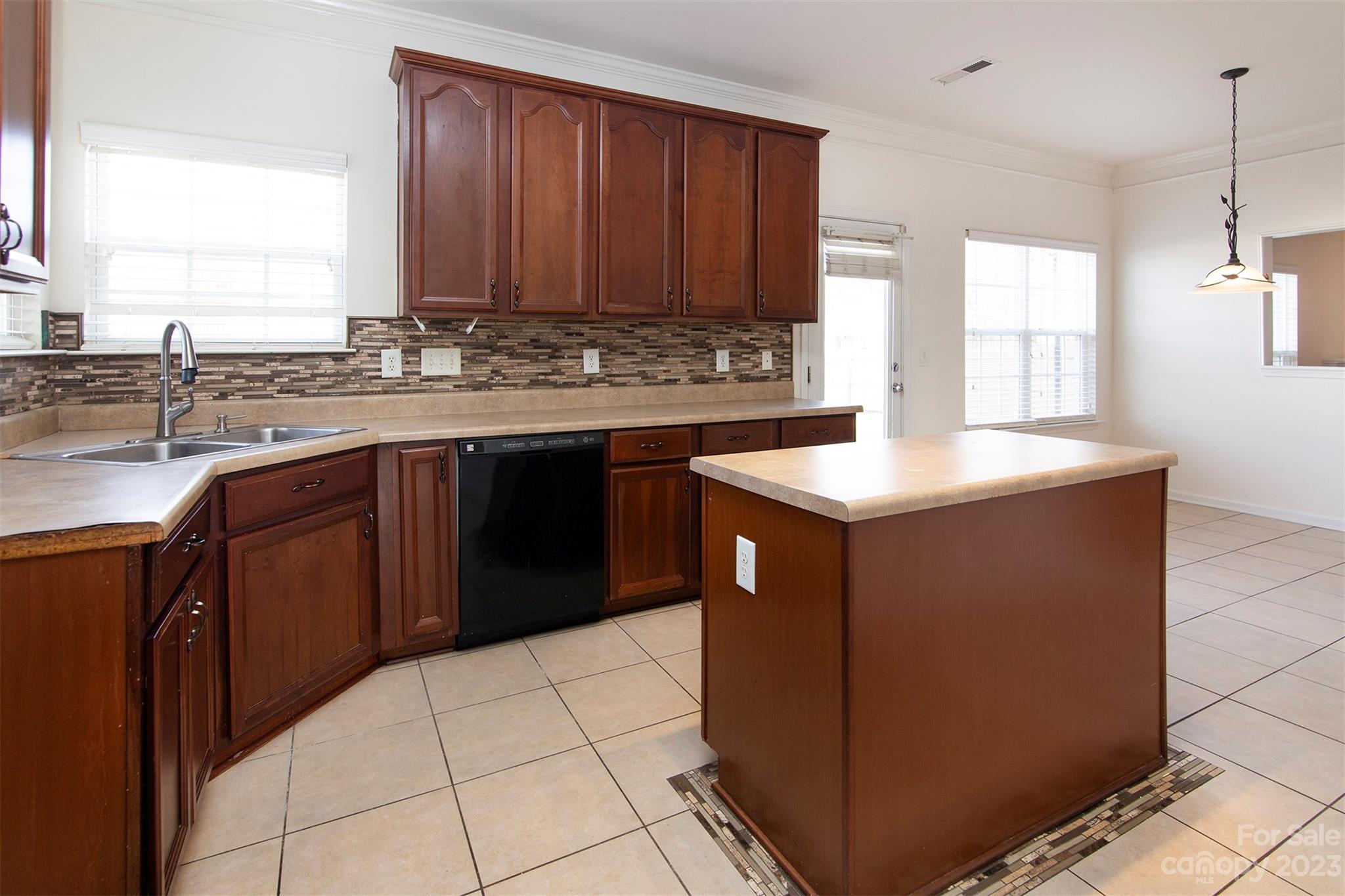 9629 Rothman Lane Charlotte, NC 28215 - Photo 9 of 24 a kitchen with stainless steel appliances granite countertop a sink counter space and a window