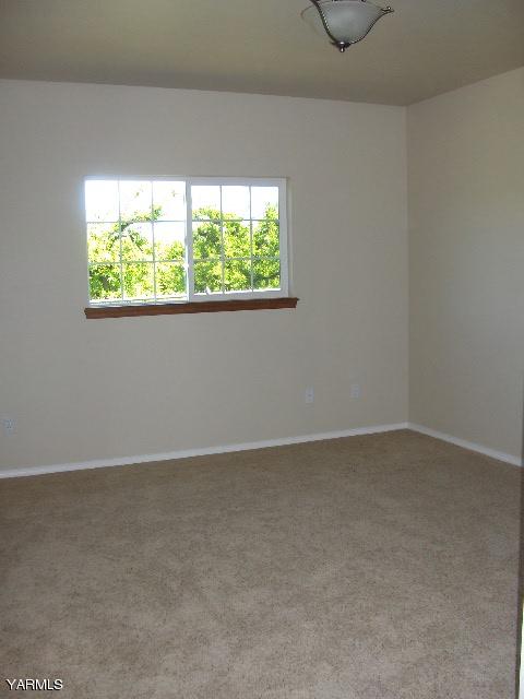 1040 Lombard Loop Road Wapato, WA 98951 - Photo 13 of 25 an empty room with a window