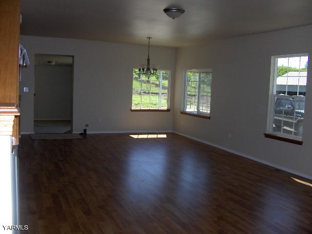 1040 Lombard Loop Road Wapato, WA 98951 - Photo 20 of 25 an empty room with wooden floor and windows