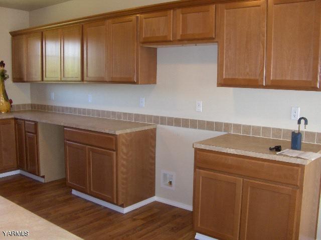 1040 Lombard Loop Road Wapato, WA 98951 - Photo 3 of 25 a kitchen with stainless steel appliances granite countertop a sink and cabinets with wooden floor