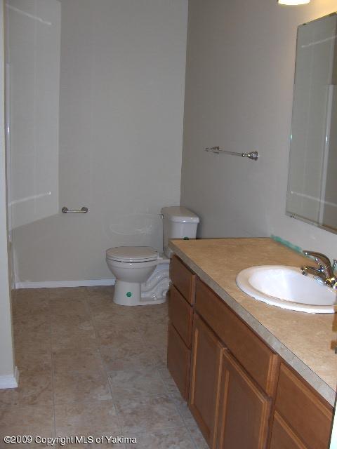 1040 Lombard Loop Road Wapato, WA 98951 - Photo 4 of 25 a bathroom with a granite countertop sink and a mirror