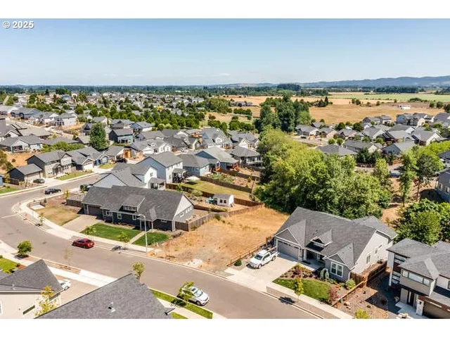an aerial view of a house with garden space and ocean view