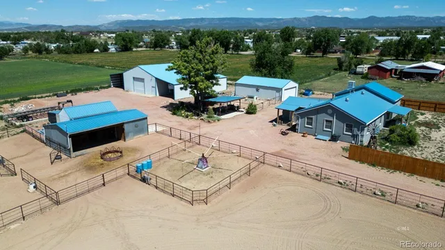 a view of a house with a big yard plants and large trees