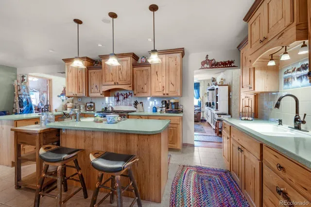 a kitchen with stainless steel appliances granite countertop sink stove and cabinets