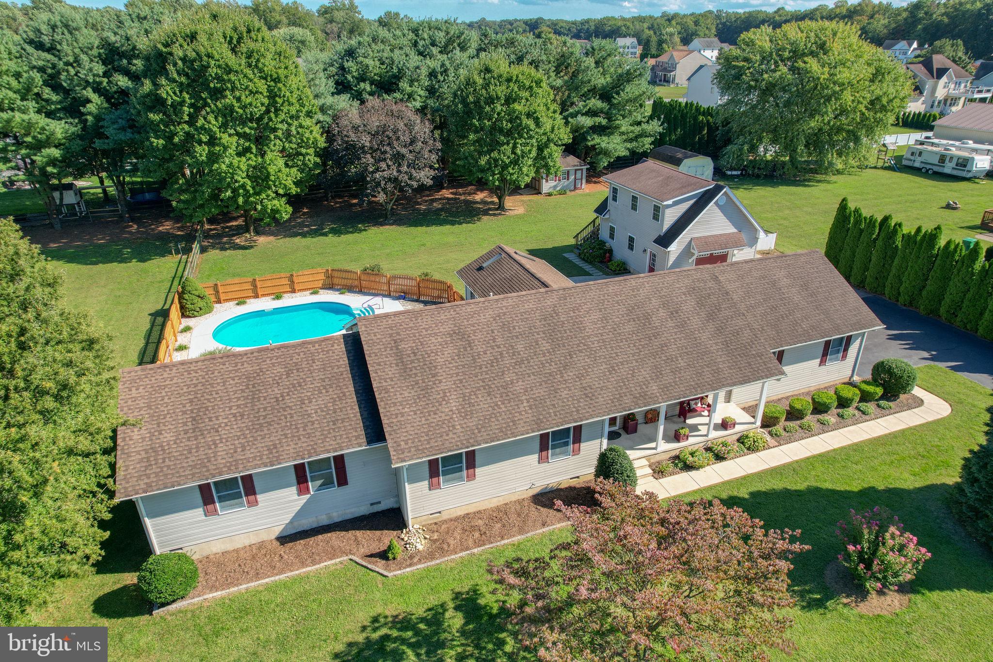 an aerial view of house with yard swimming pool and outdoor seating
