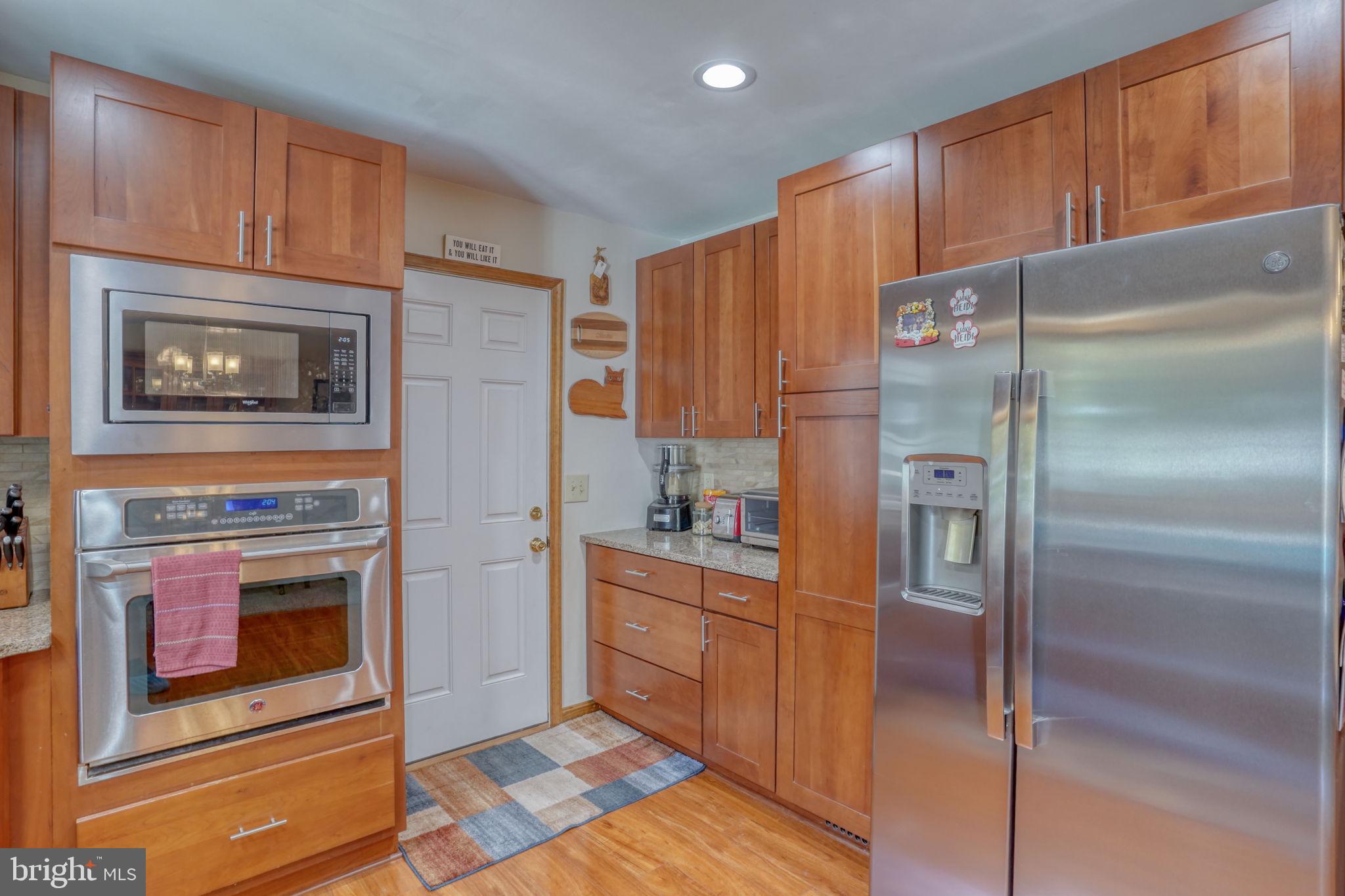 6420 Pearsons Corner Road Dover, DE 19904 - Photo 21 of 54 a kitchen with stainless steel appliances granite countertop a refrigerator and a stove top oven