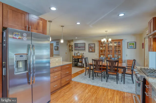 a living room with furniture a large window and a chandelier