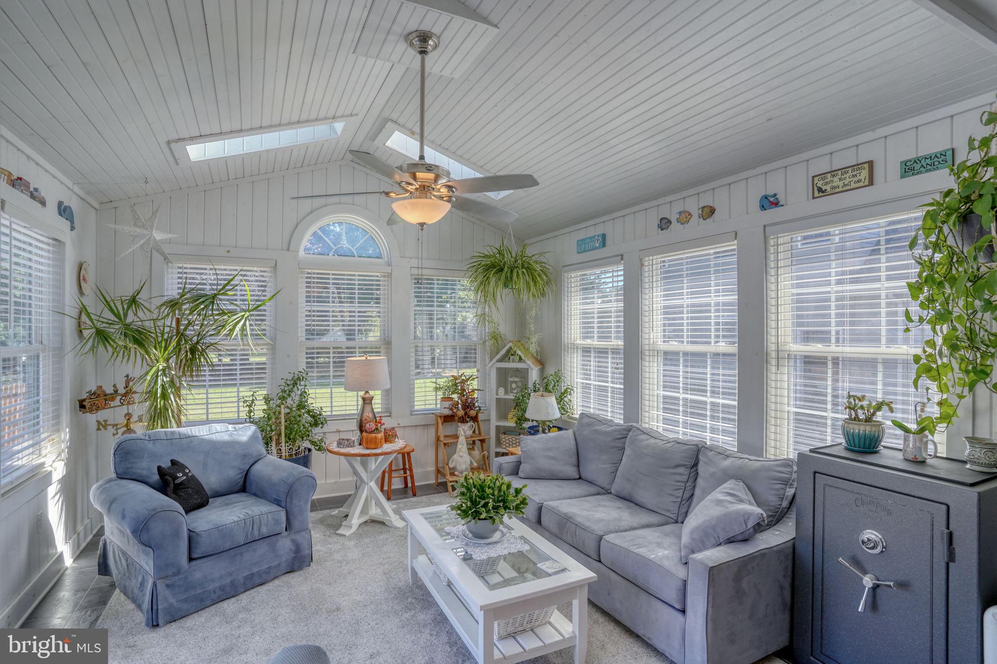 6420 Pearsons Corner Road Dover, DE 19904 - Photo 24 of 54 a living room with furniture a large window and a chandelier