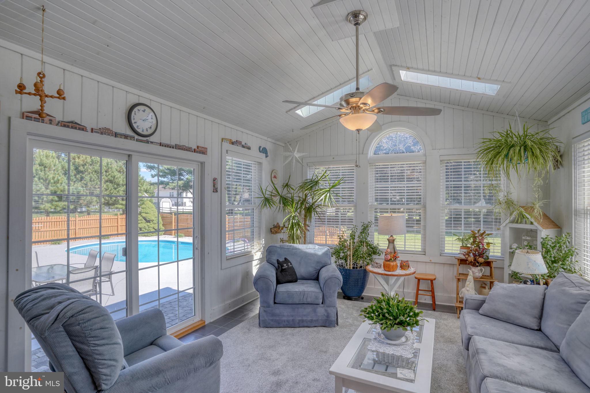 6420 Pearsons Corner Road Dover, DE 19904 - Photo 26 of 54 a living room with furniture a chandelier and a large window